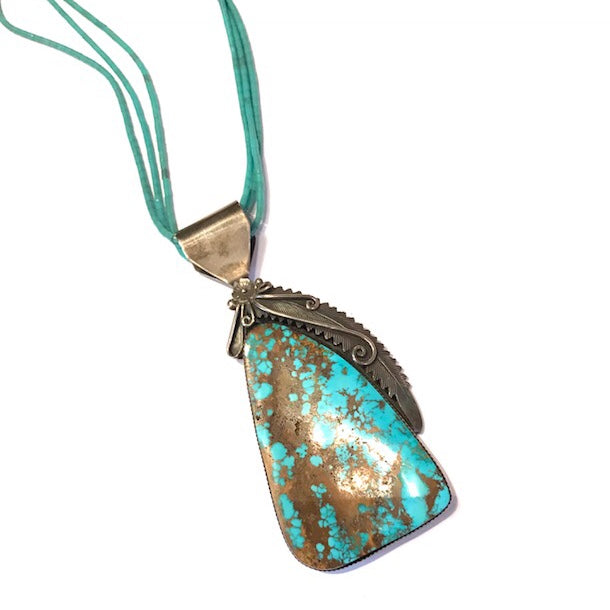 large turquoise pendant with petrified wood
