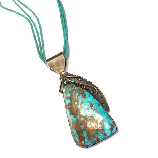 large turquoise pendant with petrified wood