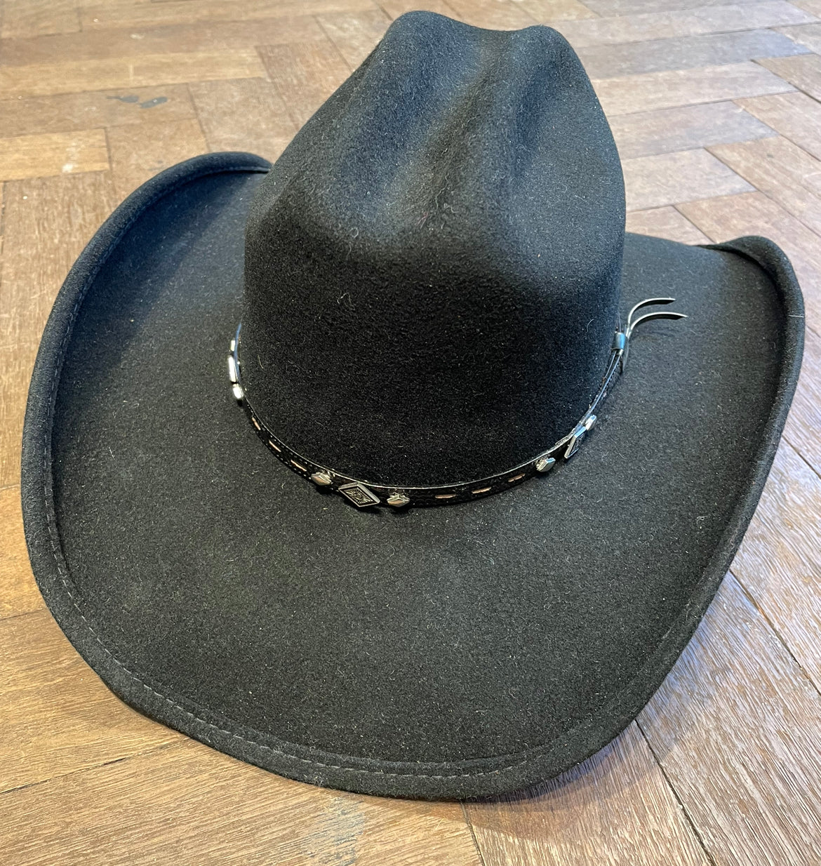 Black cowboy hat with small concho rim